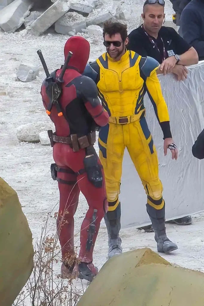 Deadpool standing triumphantly with a smirk on his face.