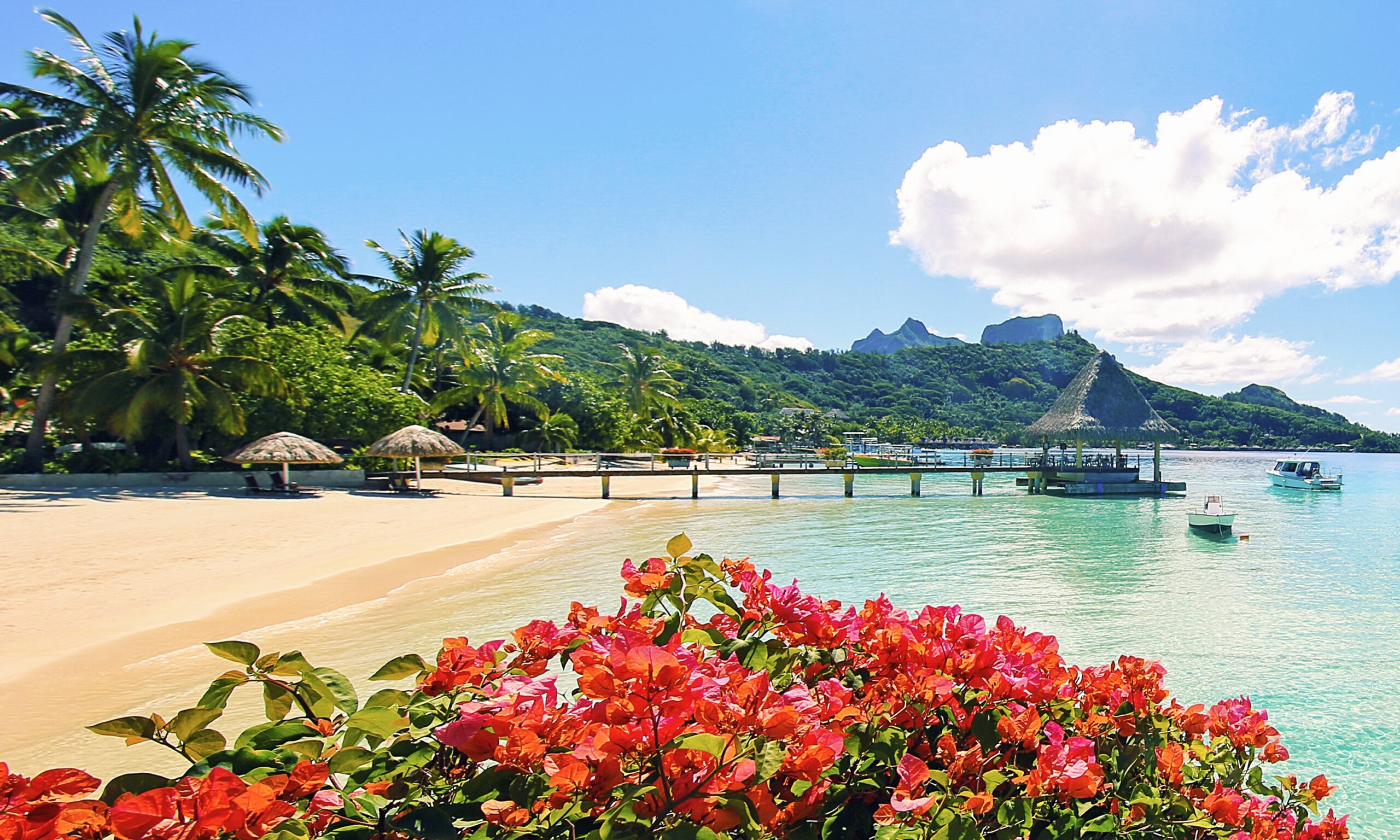 Aerial view of Bora Bora with its iconic volcanic peaks and turquoise lagoon.