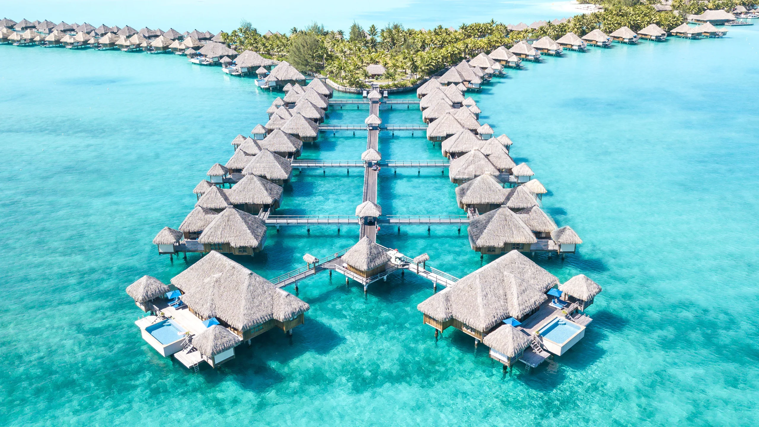 Luxury overwater bungalows in Bora Bora, surrounded by crystal-clear waters.